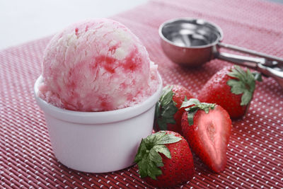 Close-up of ice cream with strawberries on place mat