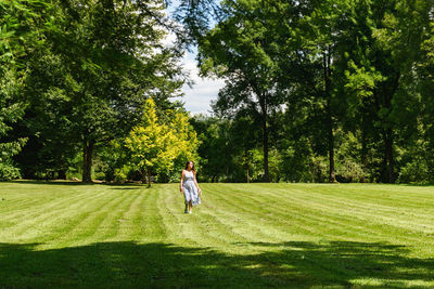 Rear view of man walking on golf course