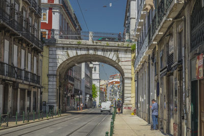 Street amidst buildings in city against clear sky