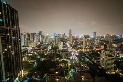 Aerial view of city lit up at night