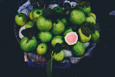 High angle view of guavas on basket for sale in market