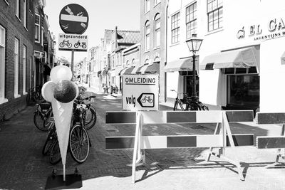 Man riding bicycle on street against buildings in city