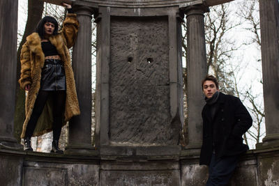 Portrait of young couple standing in snow