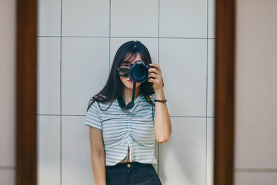 Portrait of woman photographing