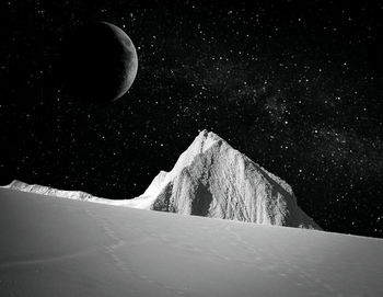 Digital composite image of snowcapped mountains at night