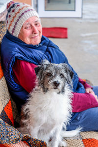 Portrait of woman with dog in winter