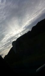 Scenic view of mountains against cloudy sky