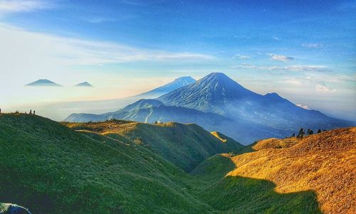 Scenic view of mountains against blue sky