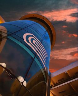 Low angle view of sign against sky at sunset