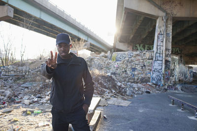 Man standing by buildings in city