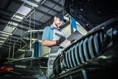 Low angle view of mechanic working in workshop