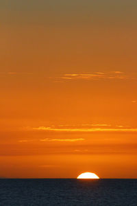 Scenic view of sea against romantic sky at sunset