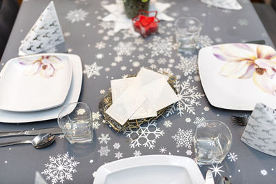 Wafer lying on the hay on the christmas table during christmas eve in poland, visible plates. 