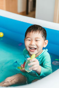 High angle view of cute boy playing with toy at home