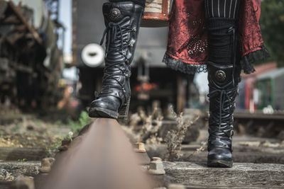 Low section of person walking on railroad track