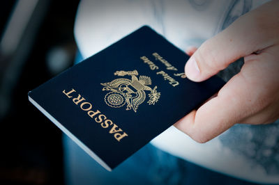 Close-up of man holding passport