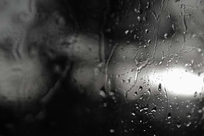 Close-up of wet glass window in rainy season