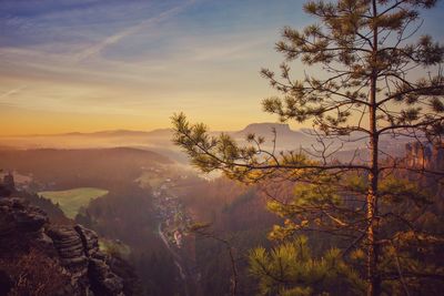 Scenic view of tree mountains against sky during sunset