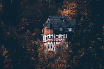 High angle view of trees and house in forest