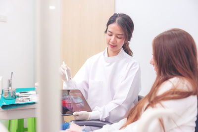 Female doctor examining patient at clinic