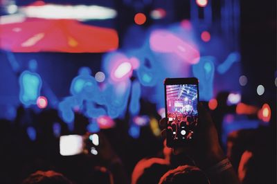 Group of people photographing at music concert