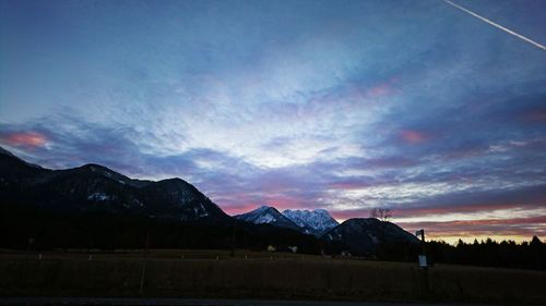 Scenic view of mountains against cloudy sky