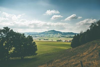 Scenic view of landscape against cloudy sky