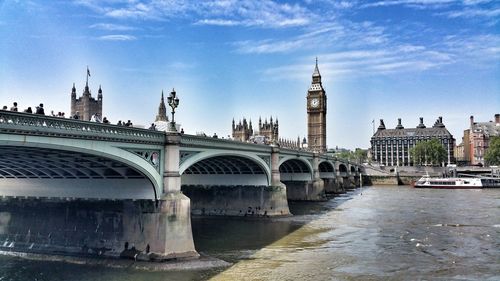 Westminster bridge over thames river against big ben in city