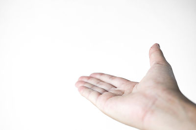 Close-up of hand against white background