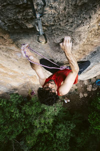 High angle view of man climbing rock