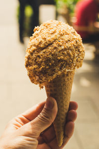 Close-up of hand holding ice cream cone