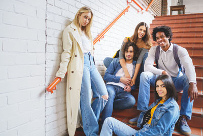 Portrait of friends sitting on steps