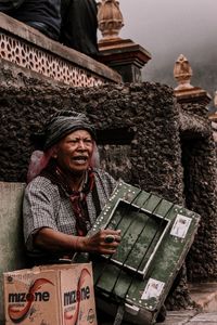 Portrait of smiling man sitting outdoors