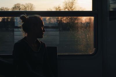 Woman looking through train window