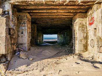 Interior of a ww2 bunker with graffiti at a french beach