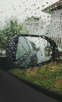 Close-up of wet car window in rainy season