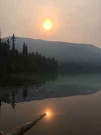 Scenic view of lake against sky during sunset