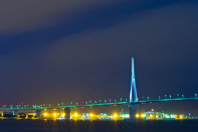 Low angle view of illuminated bridge against sky at night