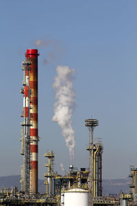 Low angle view of smoke stack against sky