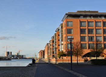 Street amidst buildings against sky in city