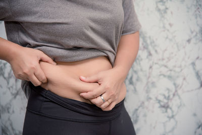 Midsection of woman holding hands
