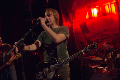 Man playing guitar at music concert