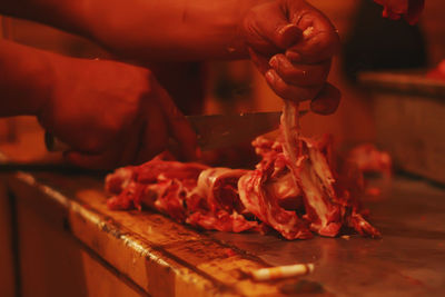 Midsection of man preparing food in the market 