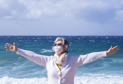 Portrait of woman in sea against sky