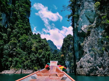 Boat in sea against mountains