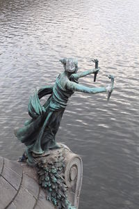 High angle view of statue by lake