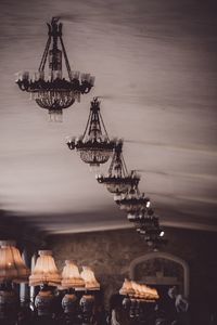 Cranes at commercial dock in sea against sky