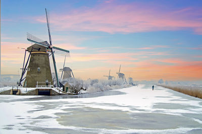 Traditonal windmills in the countryside from the netherlands in winter at sunset