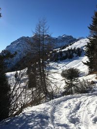 Scenic view of snow covered mountains against clear sky