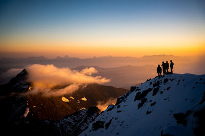 Scenic view of snowcapped mountain against sky during sunset